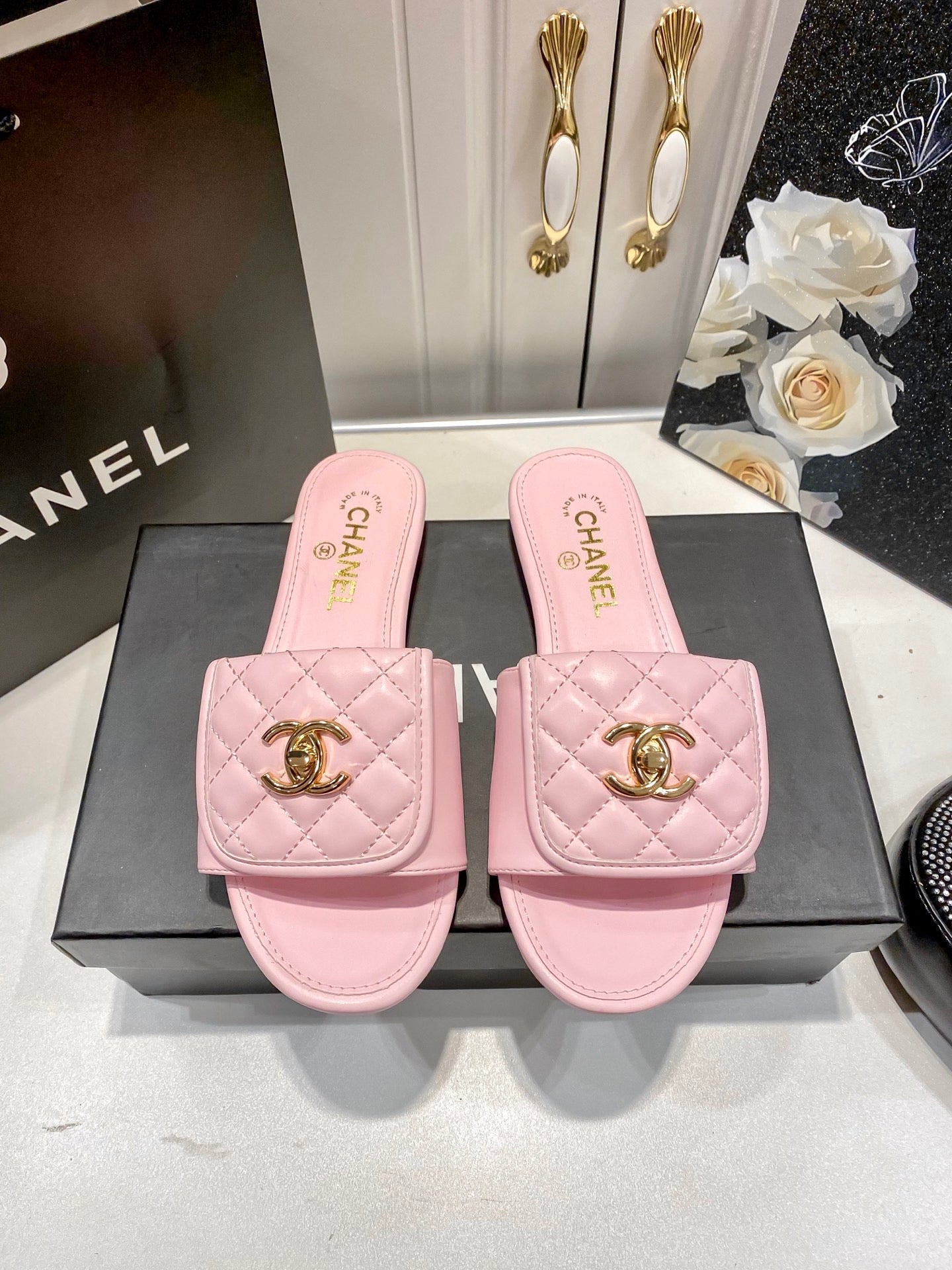 Luxury diamond-quilted flat slides with metal embellishments