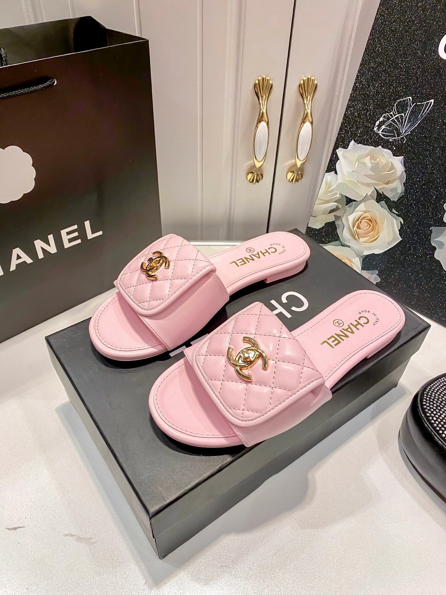 Luxury diamond-quilted flat slides with metal embellishments